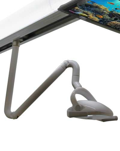 Dental operatory featuring Aurora ceiling-mounted LED light, ergonomic chair, and integrated cabinetry in a modern clinic.